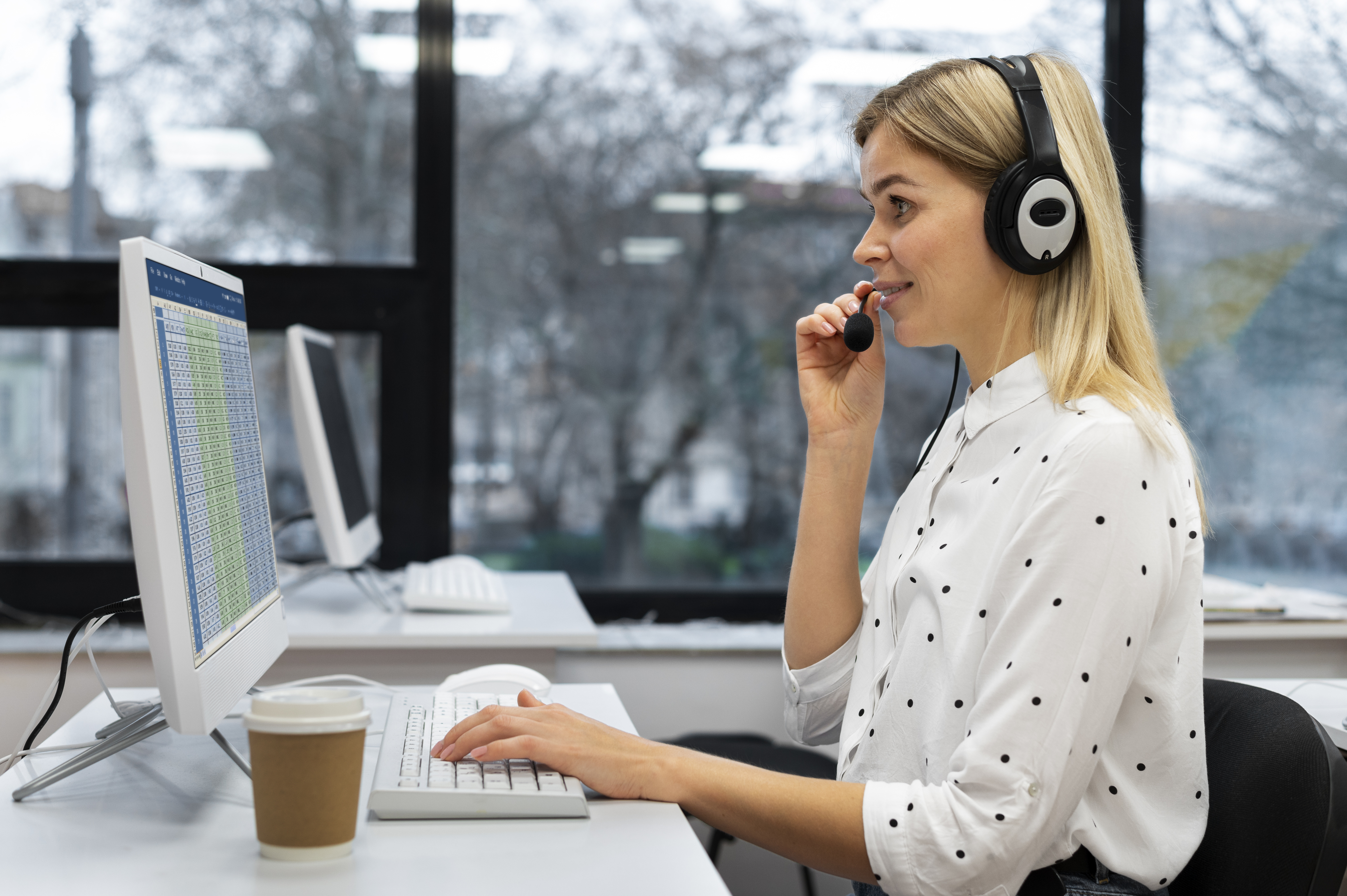 blond-woman-working-call-center-with-headphones-computer